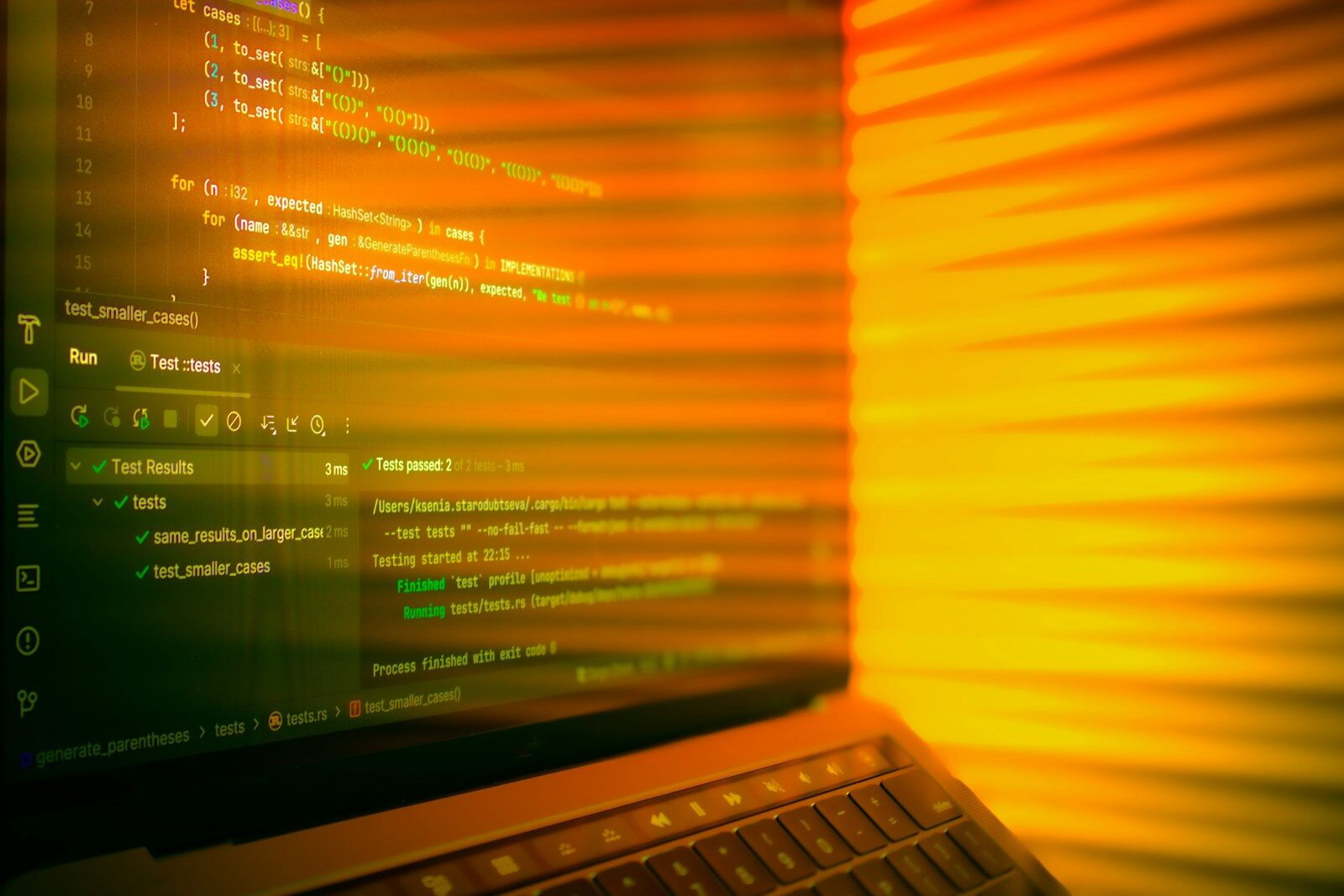 Laptop screen displaying code with orange glow